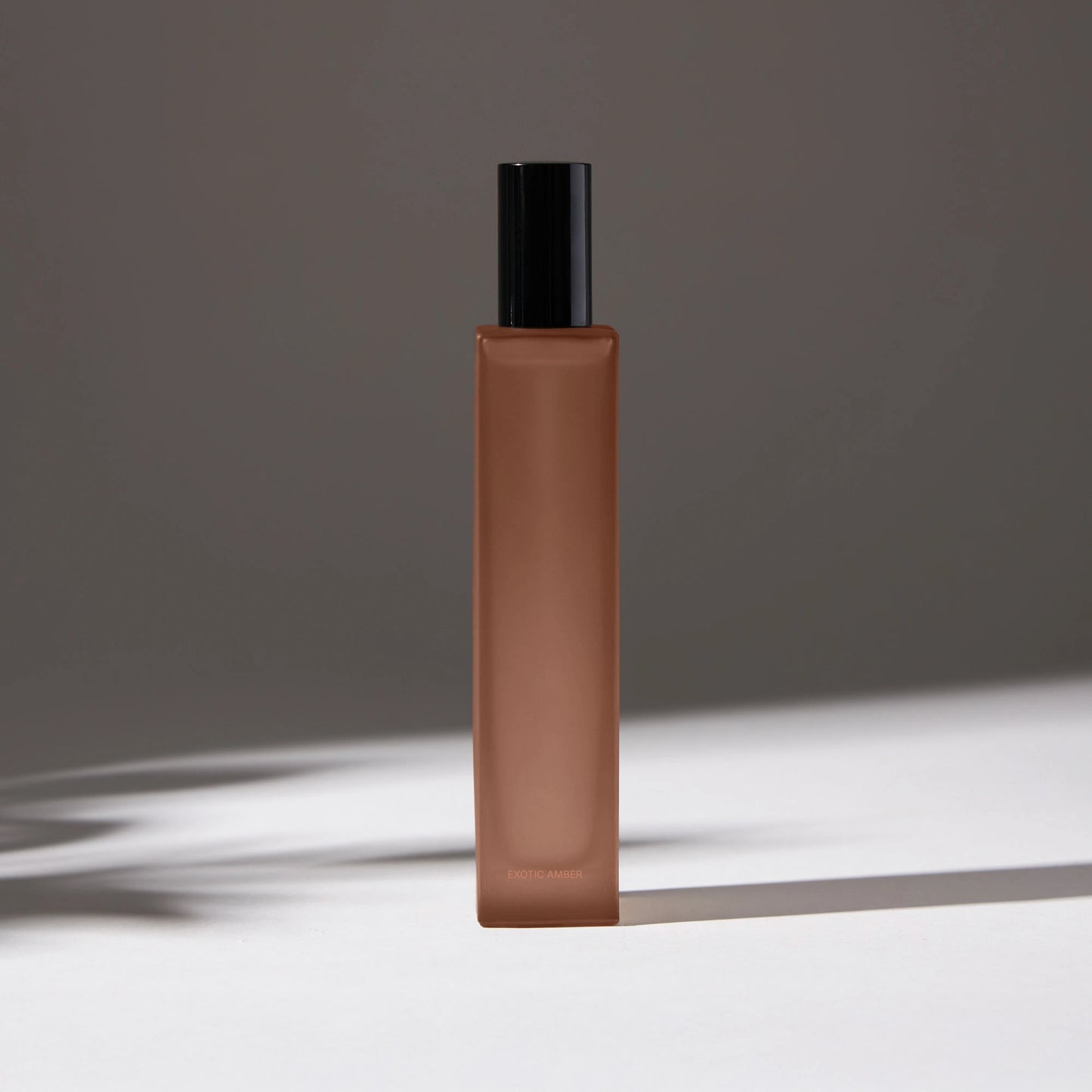 Voucler room spray bottle in dark pink with a black cap, featuring minimalist packaging on a neutral background.