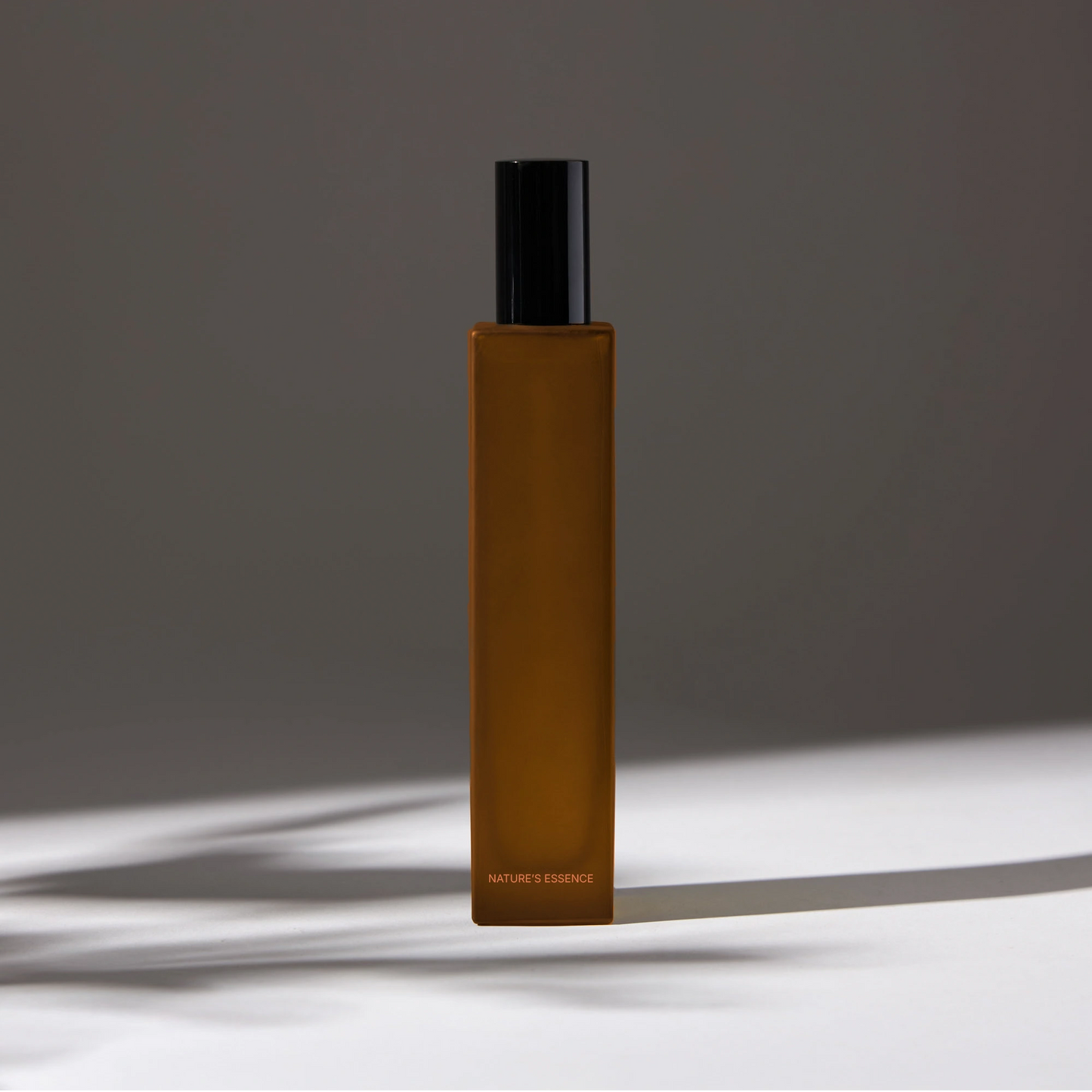 Natural essence room spray with a dark rectangular bottle and black cap, creating an elegant and minimalist look.