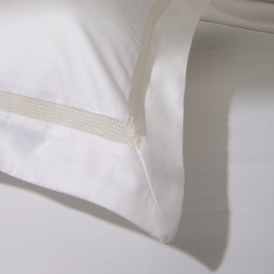 Detailed image of of the Blessing Sateen pillowcase from Voucler, with stitching details on the edge.
