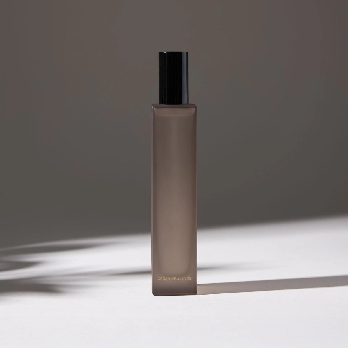 Voucler room spray bottle in dark gray with a black, highlighting the minimalist packaging on a neutral background.