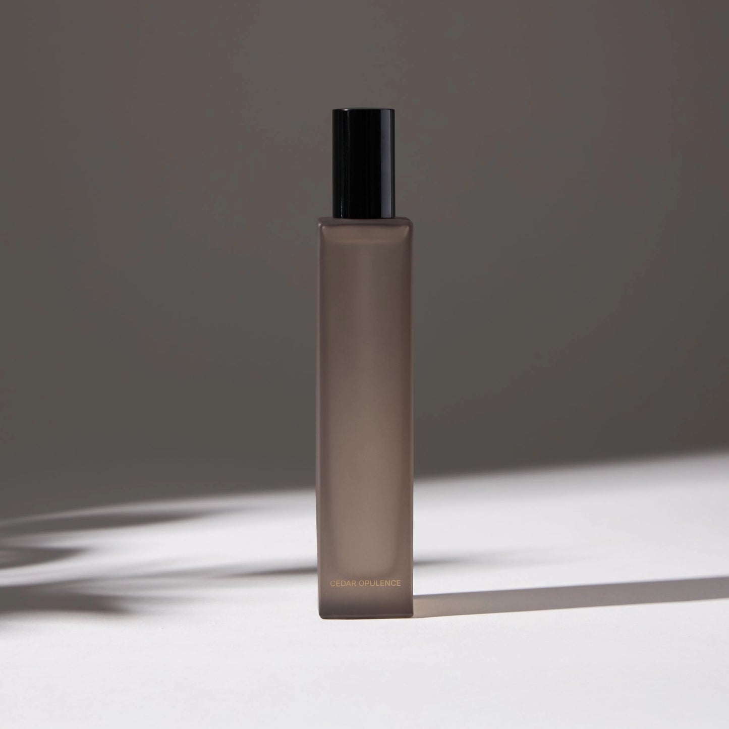 Voucler room spray bottle in dark gray with a black, highlighting the minimalist packaging on a neutral background.