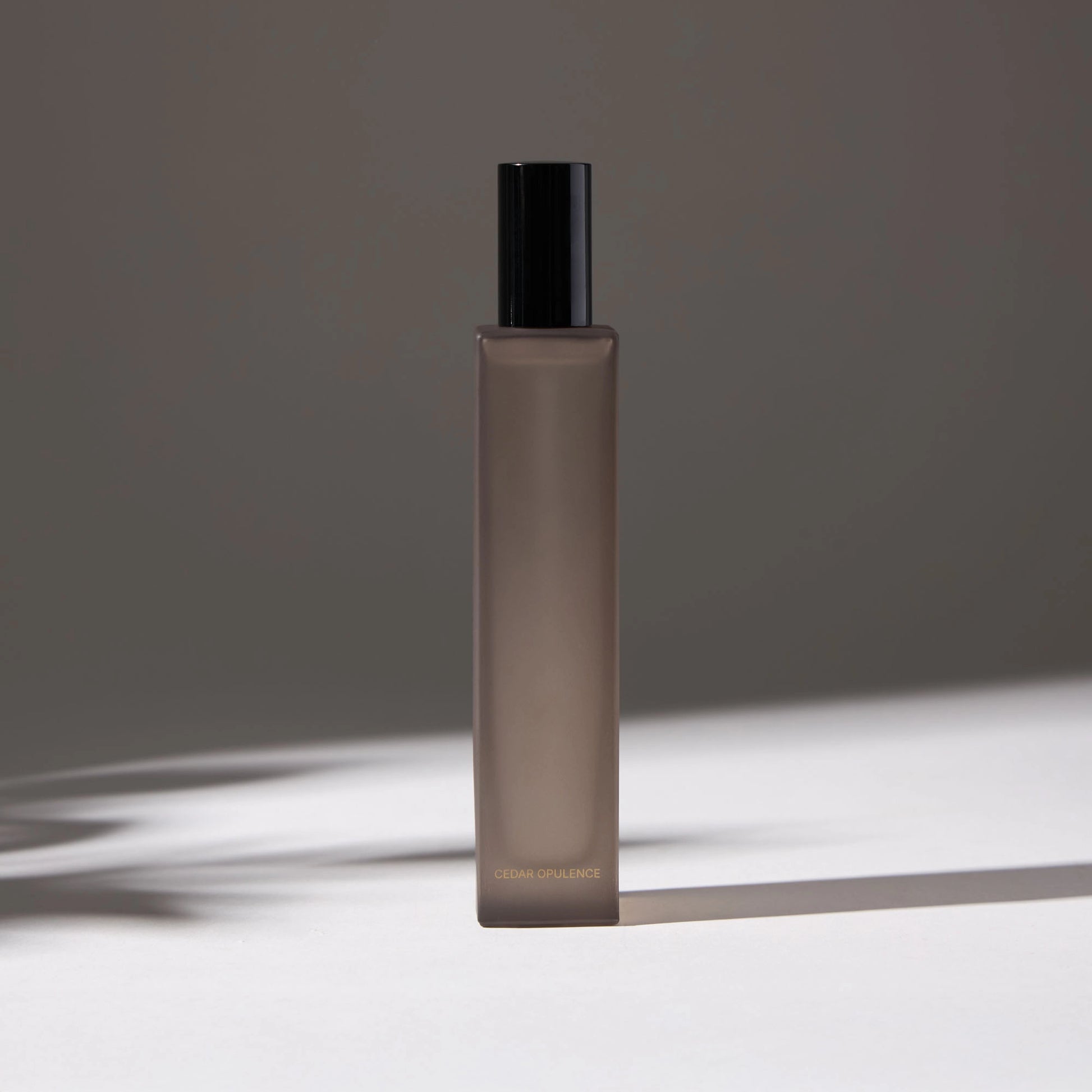 Voucler room spray bottle in dark gray with a black, highlighting the minimalist packaging on a neutral background.