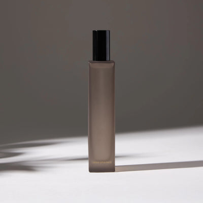 Voucler room spray bottle in dark gray with a black, highlighting the minimalist packaging on a neutral background.