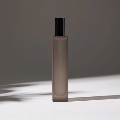 Voucler room spray bottle in dark gray with a black, highlighting the minimalist packaging on a neutral background.