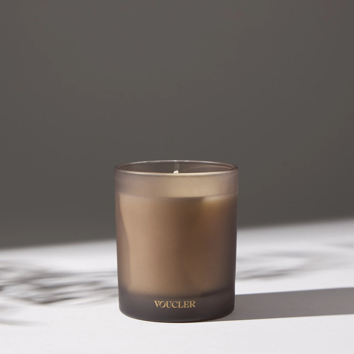 Decorative candle placed on a white surface.