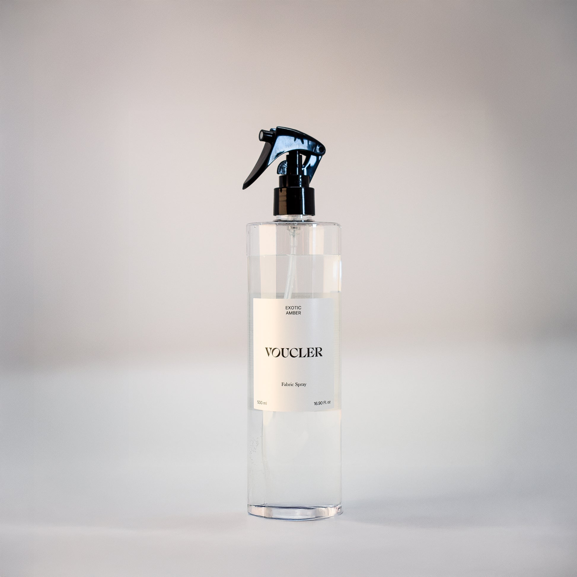 Image of the Exotic Amber fabric spray from Voucler, with a transparent packaging and white label.