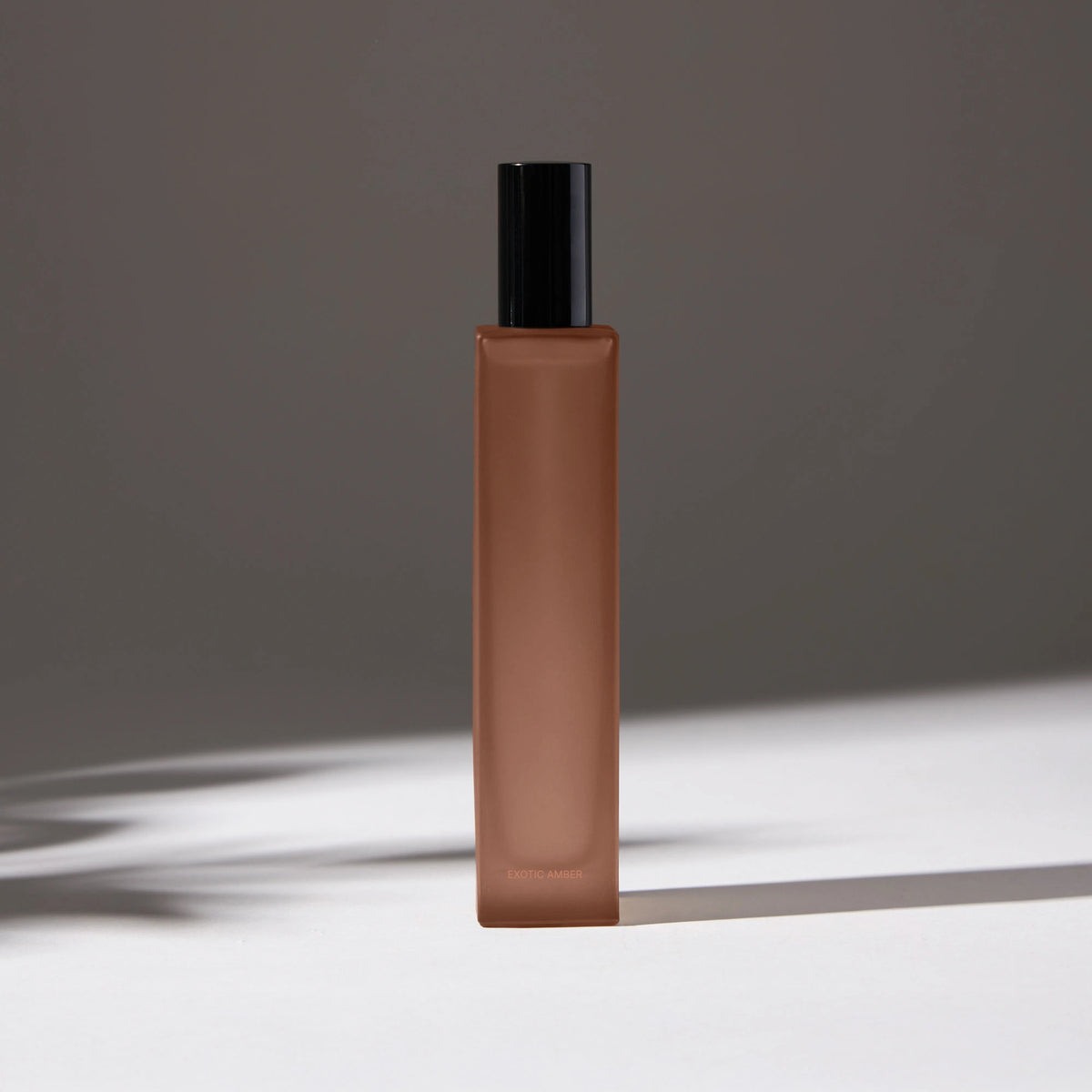 Voucler room spray bottle in dark pink with a black cap, featuring minimalist packaging on a neutral background.