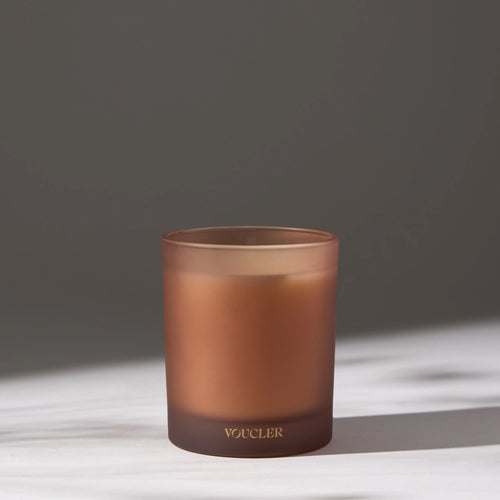 Decorative candle placed on a white surface.