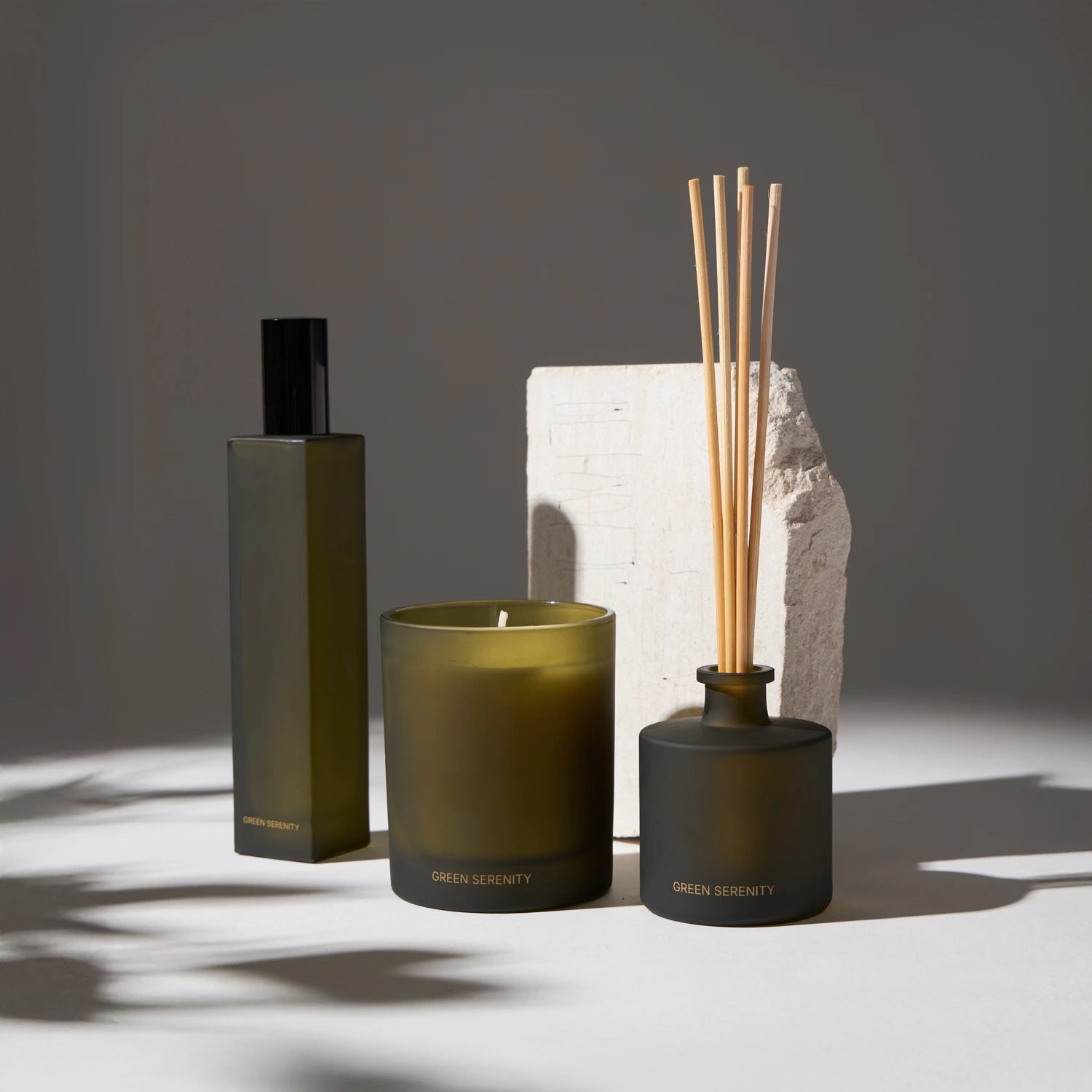 A candle, aroma diffuser, and spray set with minimalist decor in neutral tones, ideal for creating a cozy and elegant atmosphere in your home or office.