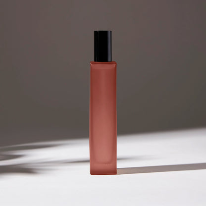 Voucler room spray bottle in light ambar with a black cap, highlighting the minimalist packaging on a neutral background.