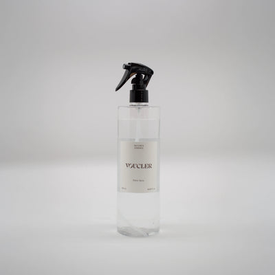 Voucler fabric spray bottle, with a black spray and a minimalist packaging on a neutral background.