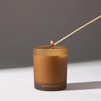 A candle with a stick inserted, placed on a white surface