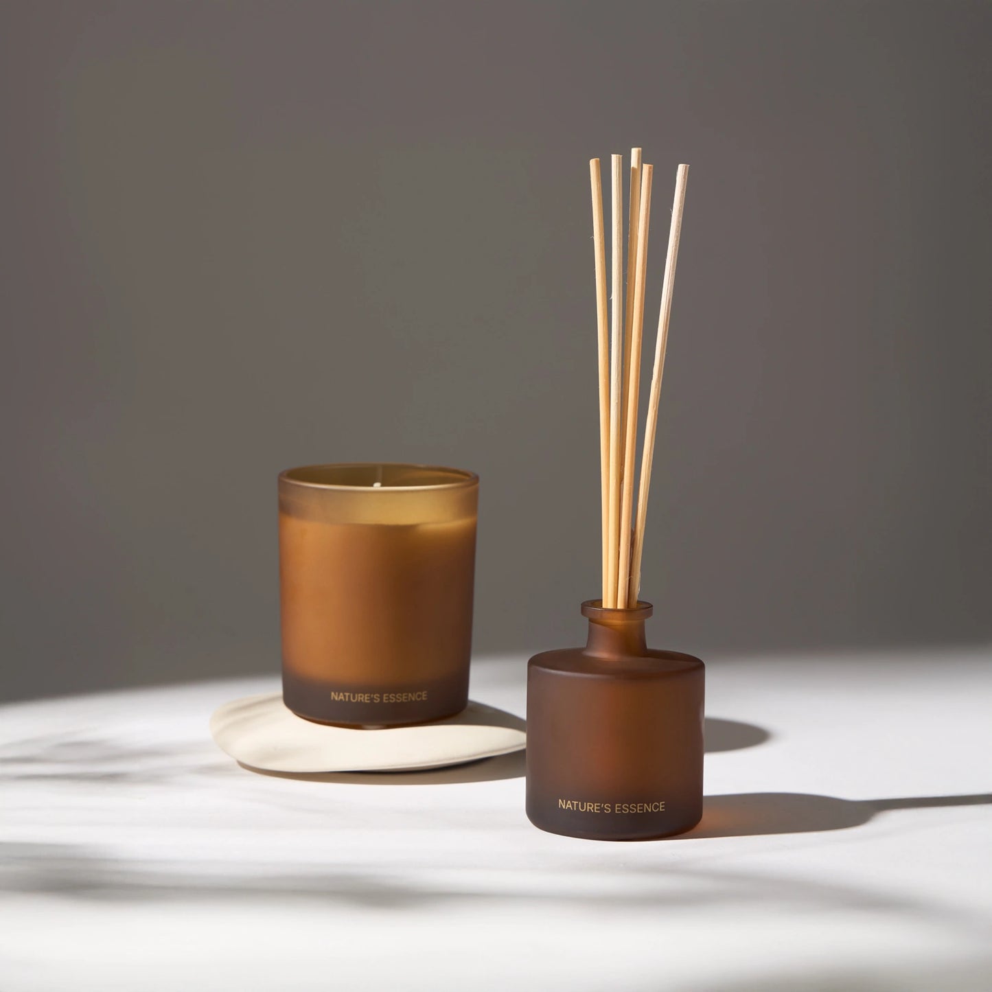 Nature's Essence scented candles and essence diffuser in a sophisticated setting, creating an atmosphere of relaxation and well-being.