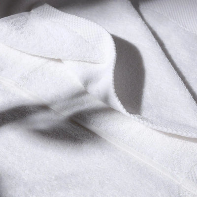 Detailed image of a white towel, conveying a feeling of cleanliness and hygiene care.