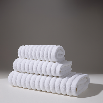 Set of soft white towels stacked in a clean and comfortable environment.