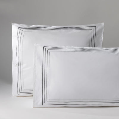 Image of two pillows with white pillowcases and a black frame, on a neutral background. Perfect for decoration or bedtime comfort.