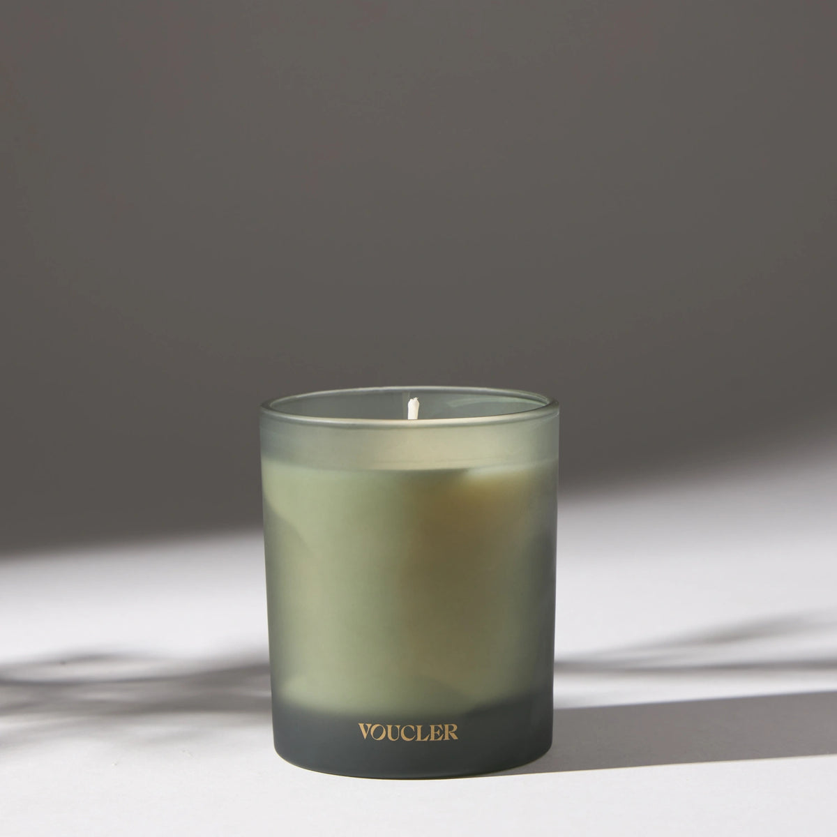 Voucler scented candle in frosted glass with soft lighting, perfect for creating a relaxing atmosphere at home.