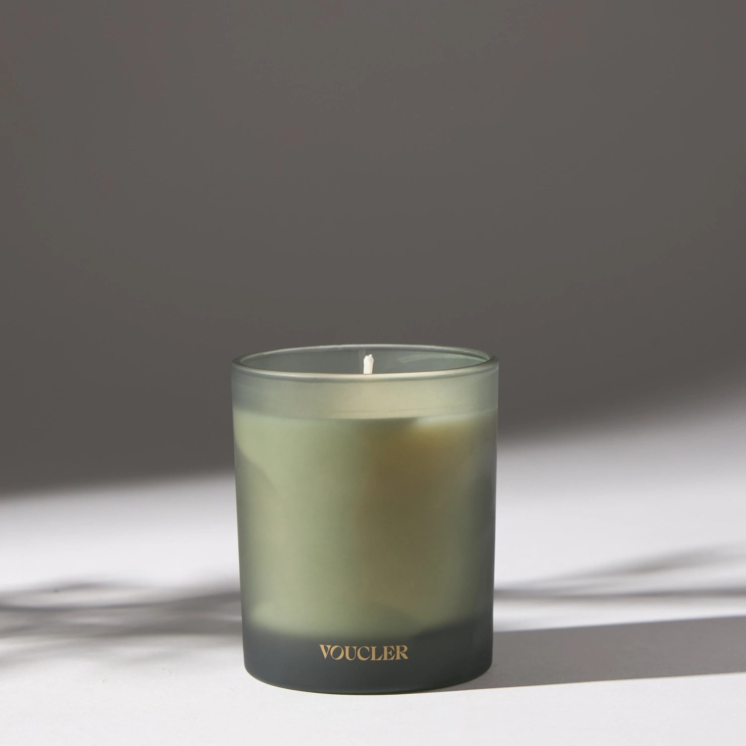 Voucler scented candle in frosted glass with soft lighting, perfect for creating a relaxing atmosphere at home.