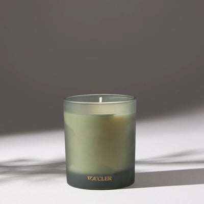 Voucler scented candle in frosted glass with soft lighting, perfect for creating a relaxing atmosphere at home.